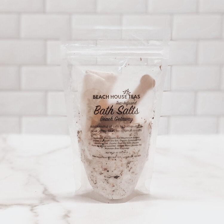 Packaged bath salts with Beach House Teas branding on a marble surface.