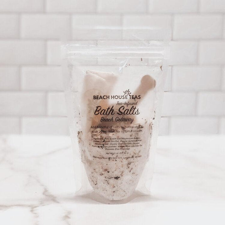 Packaged bath salts with Beach House Teas branding on a marble surface.