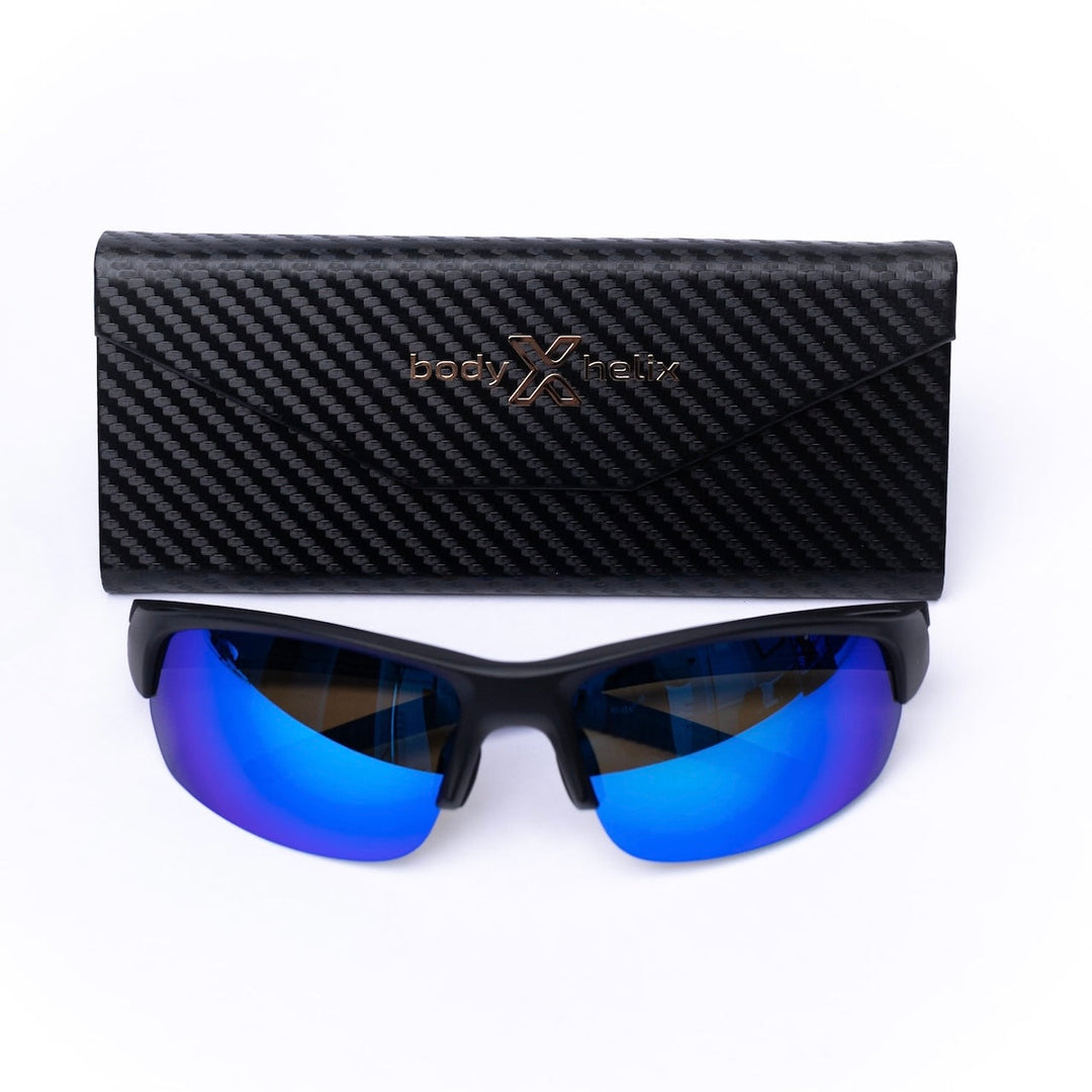 Black sunglasses with blue reflective lenses and a matching case on a white background.