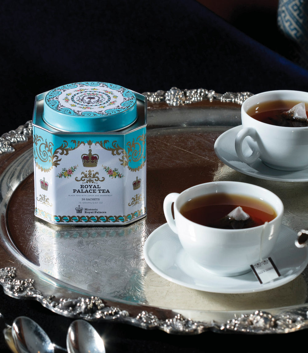 Royal Palace Tea canister with two cups of tea on a silver tray.