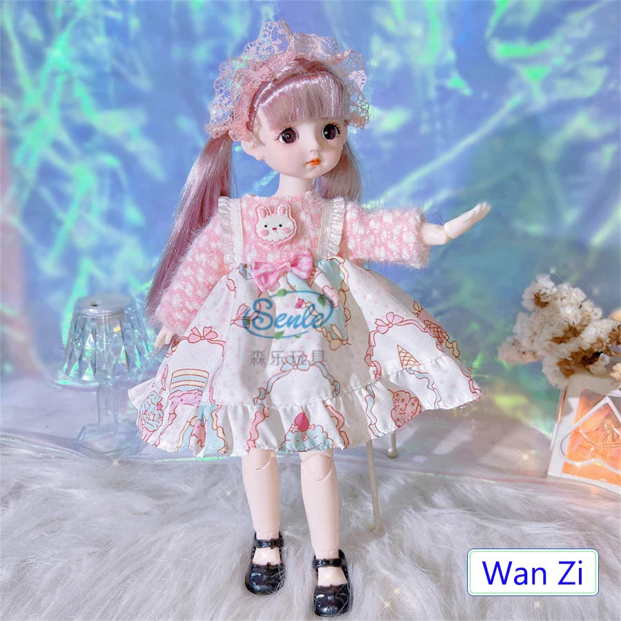Doll in a pink and white outfit with 'Eenie' branding, standing on a textured surface with a colorful background.