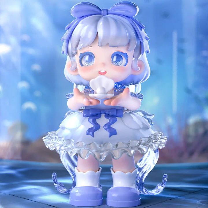 Animated character figurine with white hair and blue eyes, wearing a white dress with blue accents, on a blurred background.