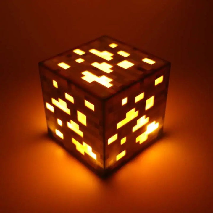 Cube-shaped light with pixelated design on an orange background.