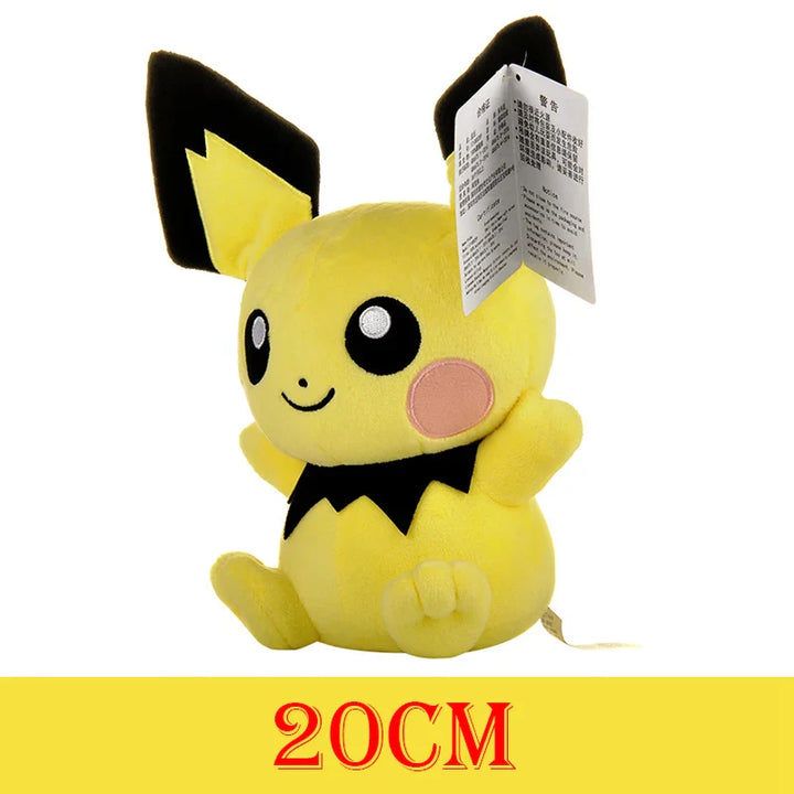 Plush toy resembling a yellow creature with black accents and a tag, on a white background.