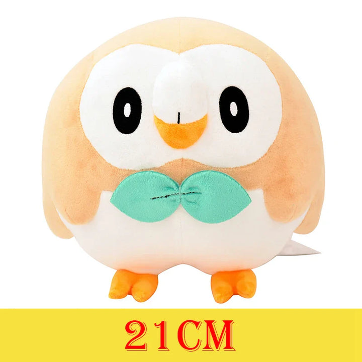 Plush toy owl with a bow tie on a white background.