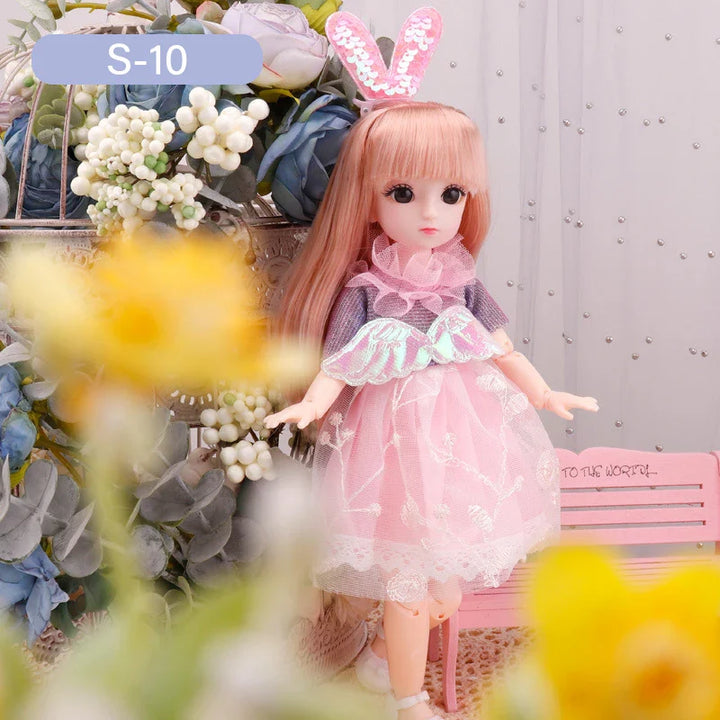 Doll with pink hair and bunny ears standing among flowers and plants.