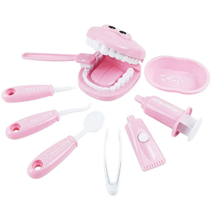 Pink dental toy set with various components on a white background.