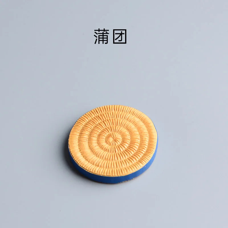 Round woven mat with concentric circles on a gray background.