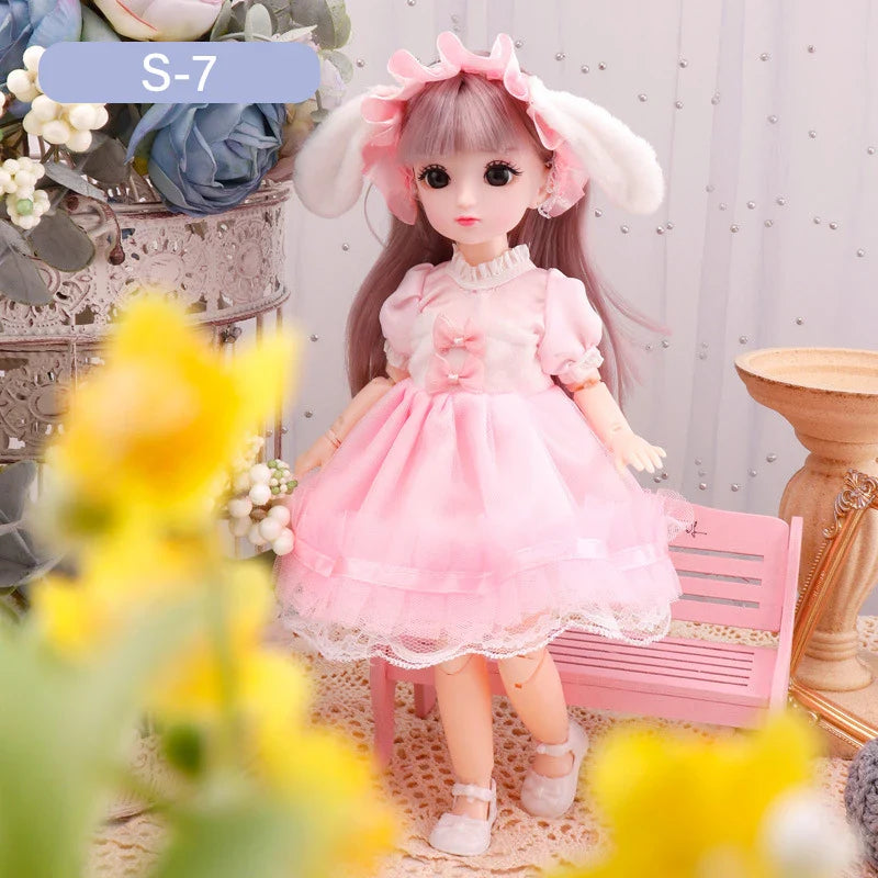 Doll in a pink dress with bunny ears sitting on a pink chair surrounded by flowers.