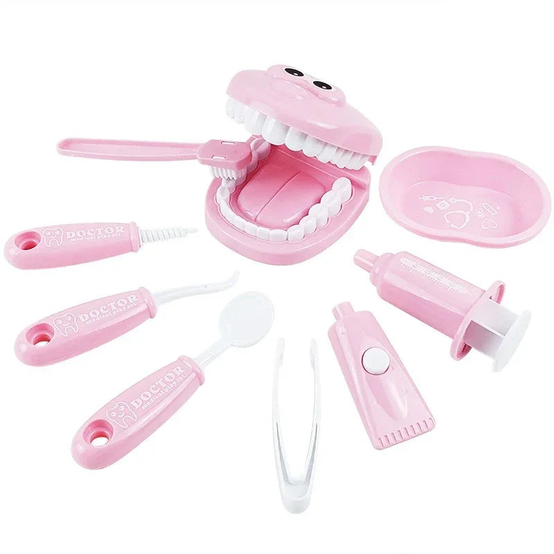 Pink toy dental set with various dental tools on a white background.