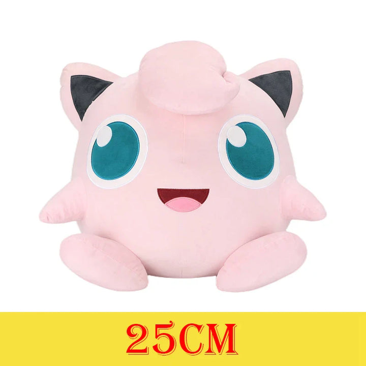 Pink plush toy with large blue eyes and a yellow bar at the bottom.