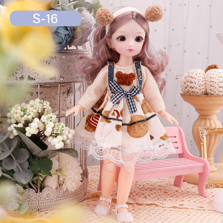 Doll in a decorative setting with flowers and a pink chair.