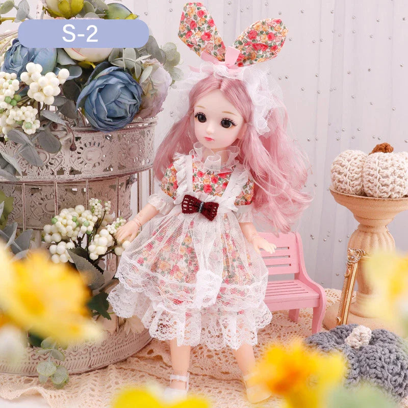 Doll with floral bunny ears and a floral dress in a decorative setting with flowers and a pink chair.