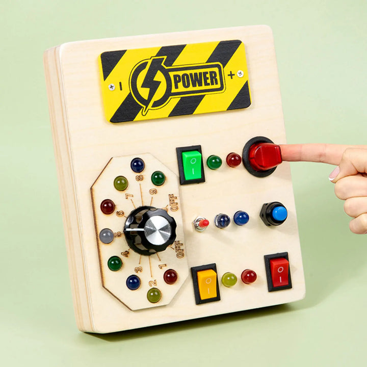 Control panel with buttons and a hand pressing a red switch on a light green background.