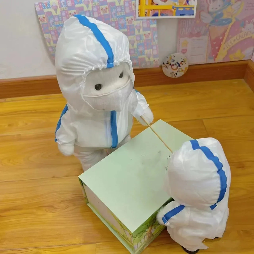 Two children in full-body protective suits with blue stripes standing on a wooden floor.