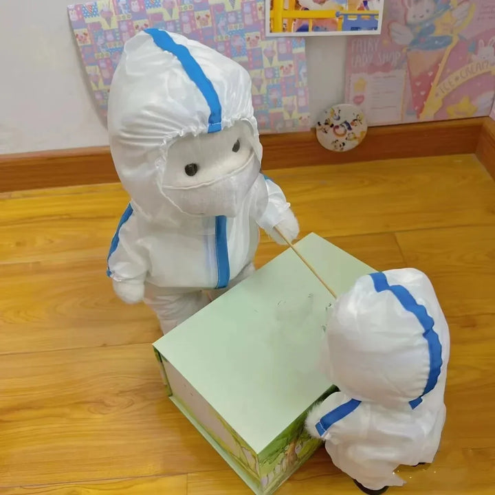 Two children in full-body protective suits with blue stripes standing on a wooden floor.