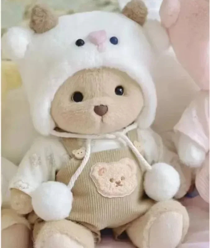 Teddy bear wearing a white hood with bear ears and a matching outfit.