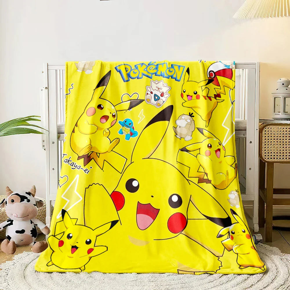 Yellow Pikachu blanket with multiple Pikachu illustrations on a white background.