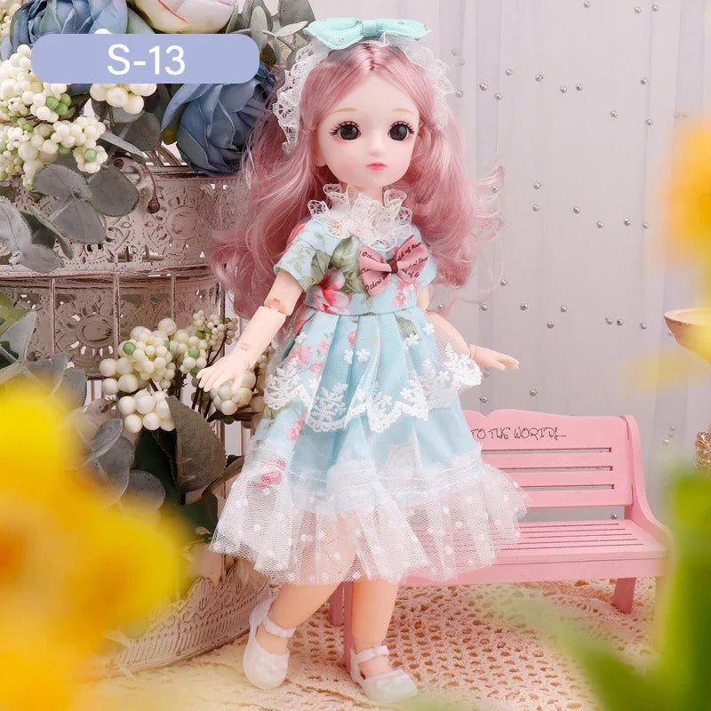 Doll with pink hair and a blue dress standing in a decorative setting with flowers and a bench.
