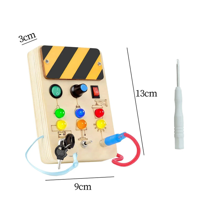 Wooden toy control panel with buttons and wires, measurements indicated, on a white background.