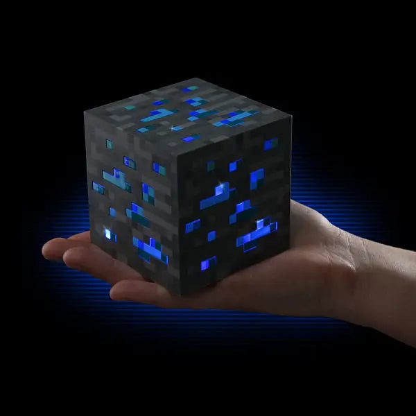 Hand holding a glowing pixelated cube against a dark background.