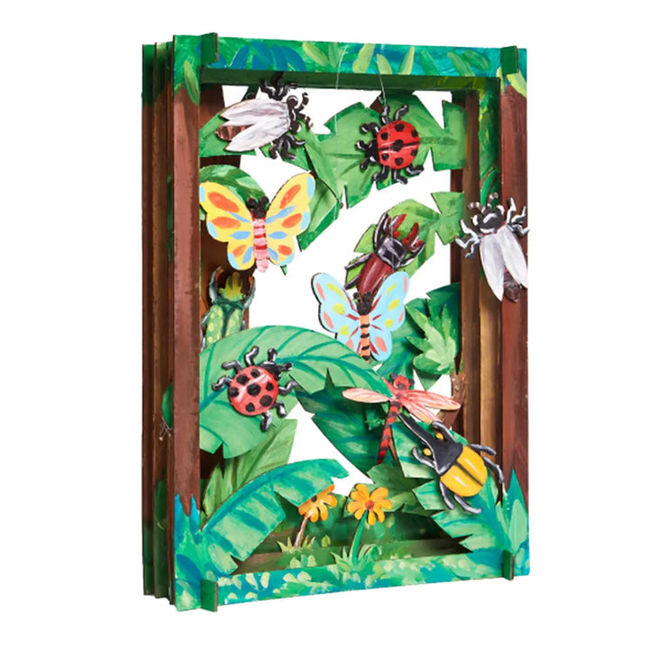 Shadow box with colorful illustrations of insects and foliage on a white background.