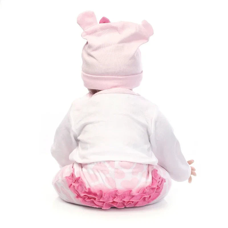 Stuffed animal toy in a pink outfit with a white background.