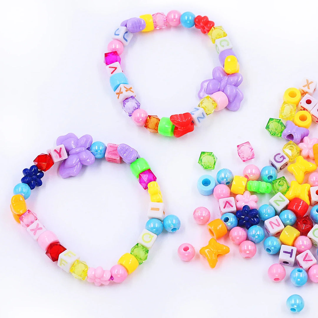 Colorful beaded bracelets with letters and shapes on a white background.