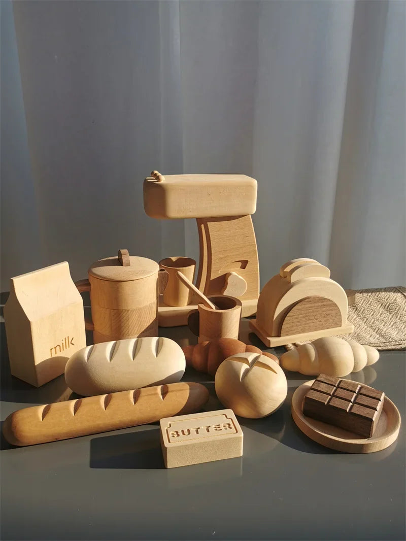Collection of wooden food items and kitchenware on a reflective surface with a neutral background.