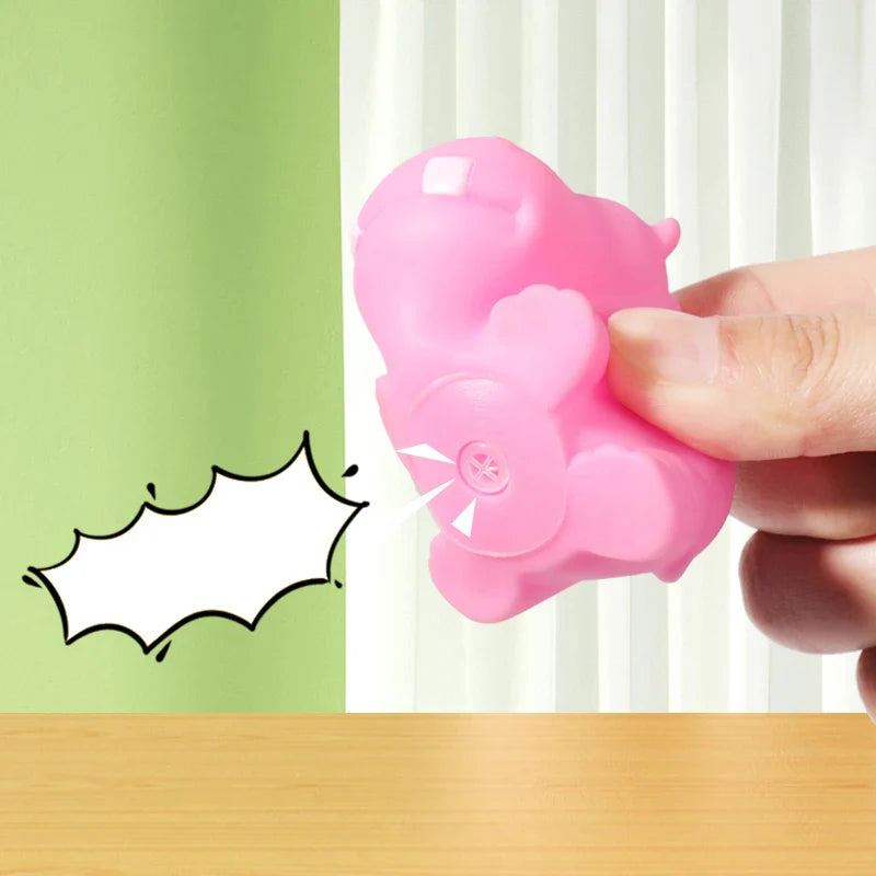 Pink flower-shaped object held by a hand with a green and white background.