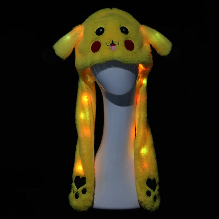 Plush toy with a glowing yellow hood on a black background.