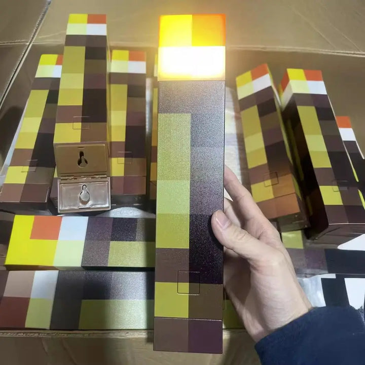 Stack of checkered boxes with a hand holding one, on a reflective surface.