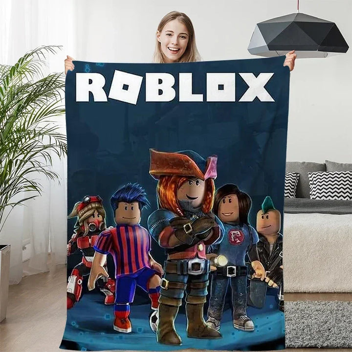 Person holding a Roblox-themed blanket with characters in a living room.