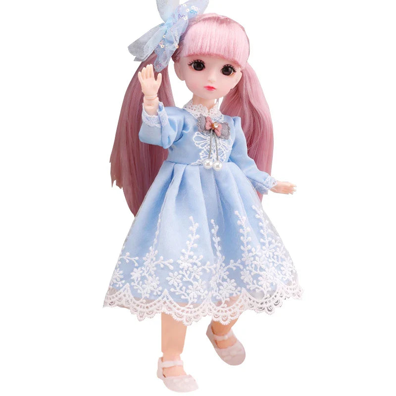 Doll with pink hair and a blue dress on a white background.