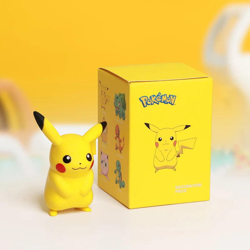 Yellow Pikachu figurine next to its packaging box on a yellow background.