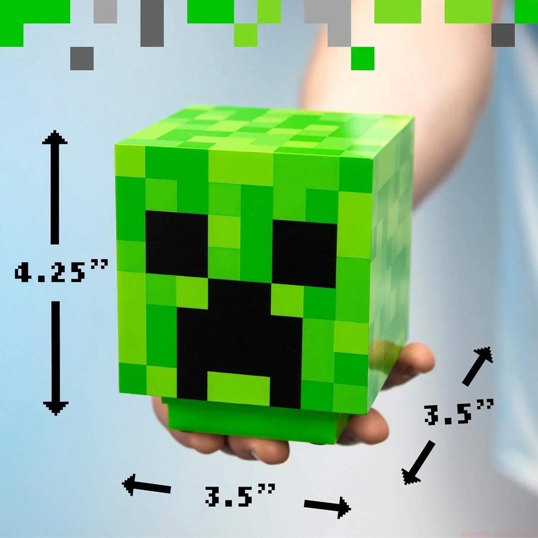 Green block-shaped toy with pixelated design held by a hand, showing dimensions.