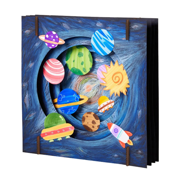 Colorful space-themed pop-up book with planets and rockets on a blue background.