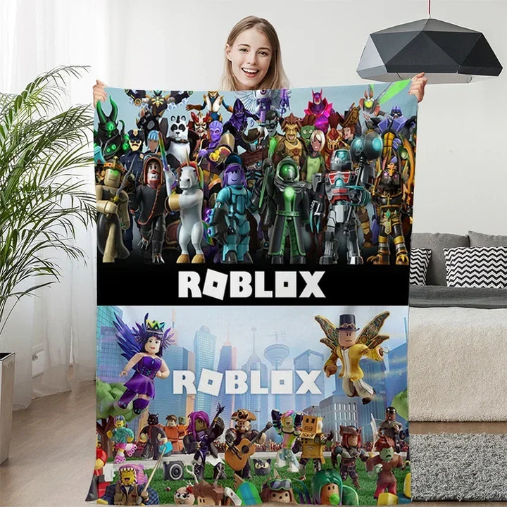 Person holding a Roblox-themed blanket with character images and Roblox branding.
