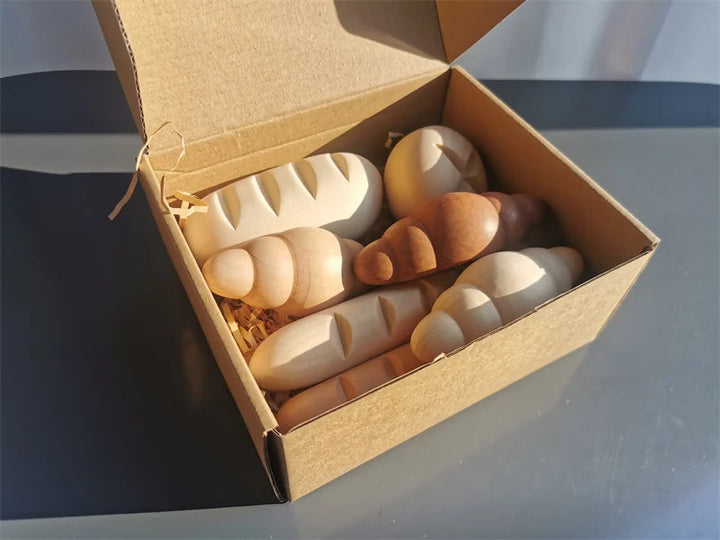 Box of wooden toys on a reflective surface.