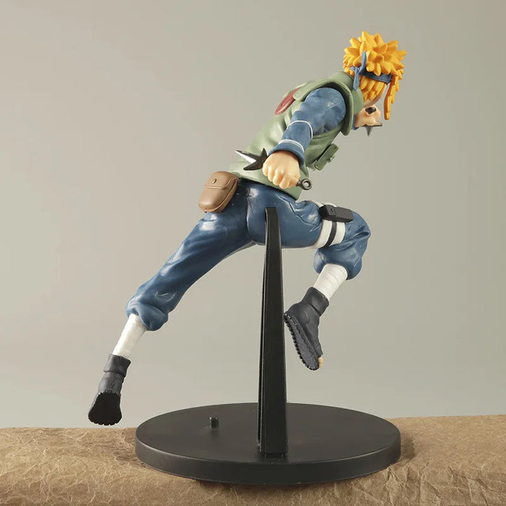 Action figure of a character from an anime on a stand with a neutral background.