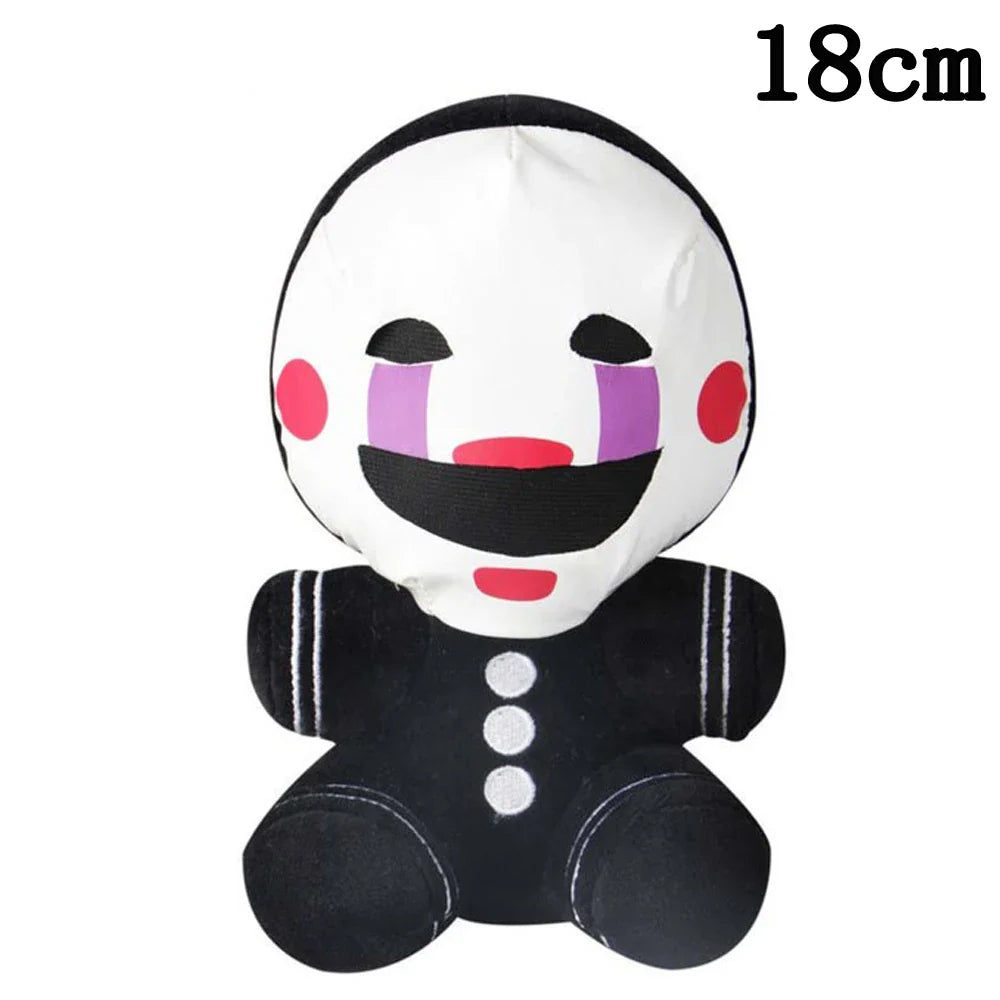 Small plush toy with a white face, black hair, and black body on a white background.