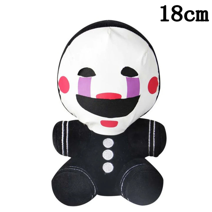 Small plush toy with a white face, black hair, and black body on a white background.