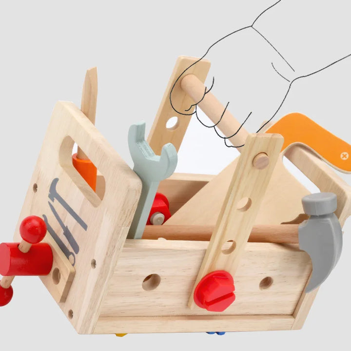 Wooden toy toolbox with tools on a light gray background.