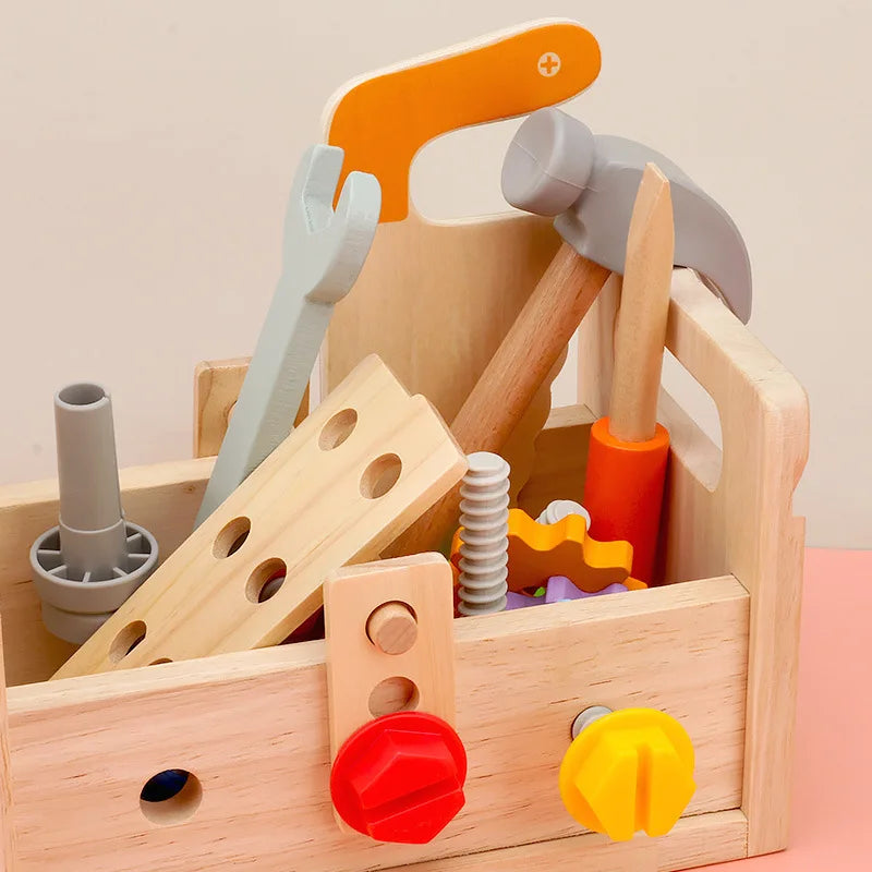 Wooden toy toolbox with colorful tools on a light background.