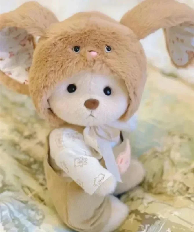 Plush toy bear with a white outfit on a soft, light-colored background.
