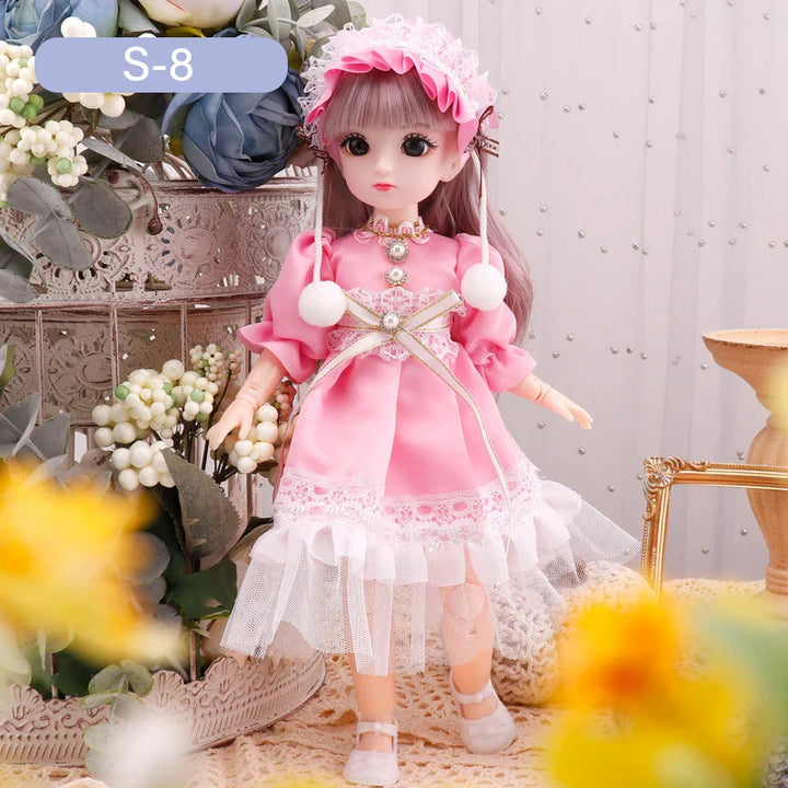 Doll in a pink dress with flowers and decorative elements in the background.