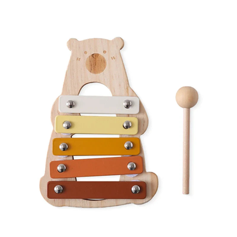 Wooden bear xylophone with a mallet on a white background.