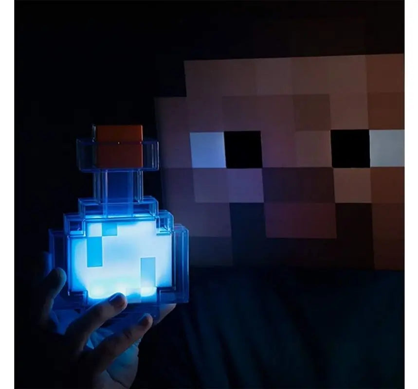 Pixelated character light held by a hand with a dark background.