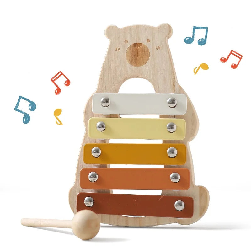 Wooden xylophone shaped like a bear with musical notes around it on a white background.