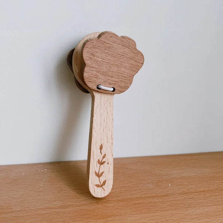 Wooden toy with a floral design on a wooden surface.